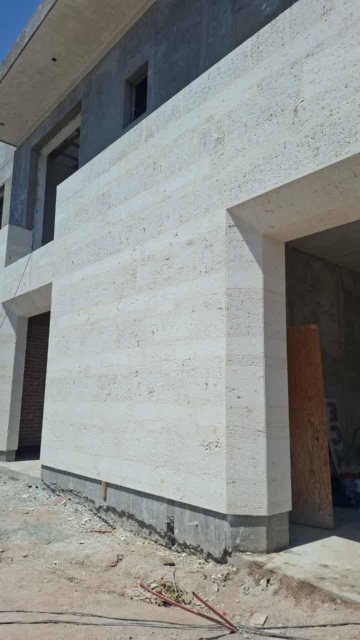Two-storey facade · travertine-look cladding — Private residence