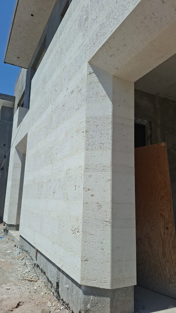 Entry volume · limestone cladding — Private residence