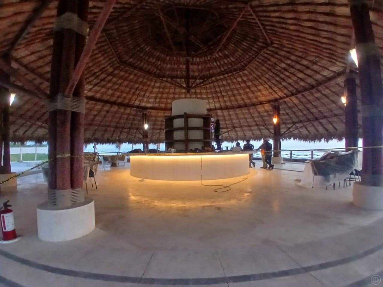 Curved stone bar under a palapa