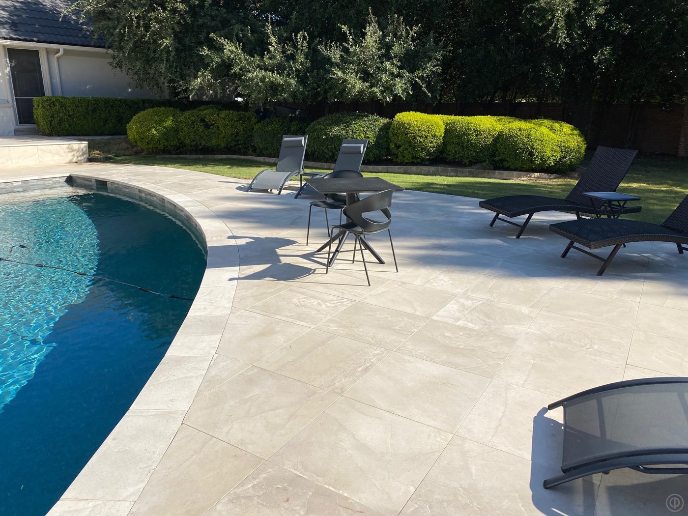 Large-format limestone pavers around a pool