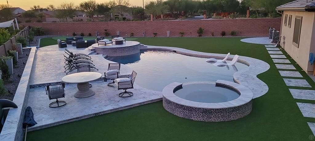Pool and raised spa with stone coping